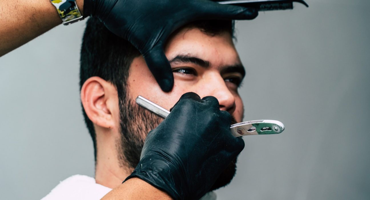 Person Shaving a Man's Face With Straight Razor