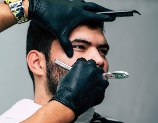 Person Shaving a Man's Face With Straight Razor